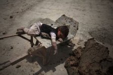A child slept on a cart at a brick factory in Kabul, Afghanistan. - Ahmad Massoud-Xinhua via Zum.jpg